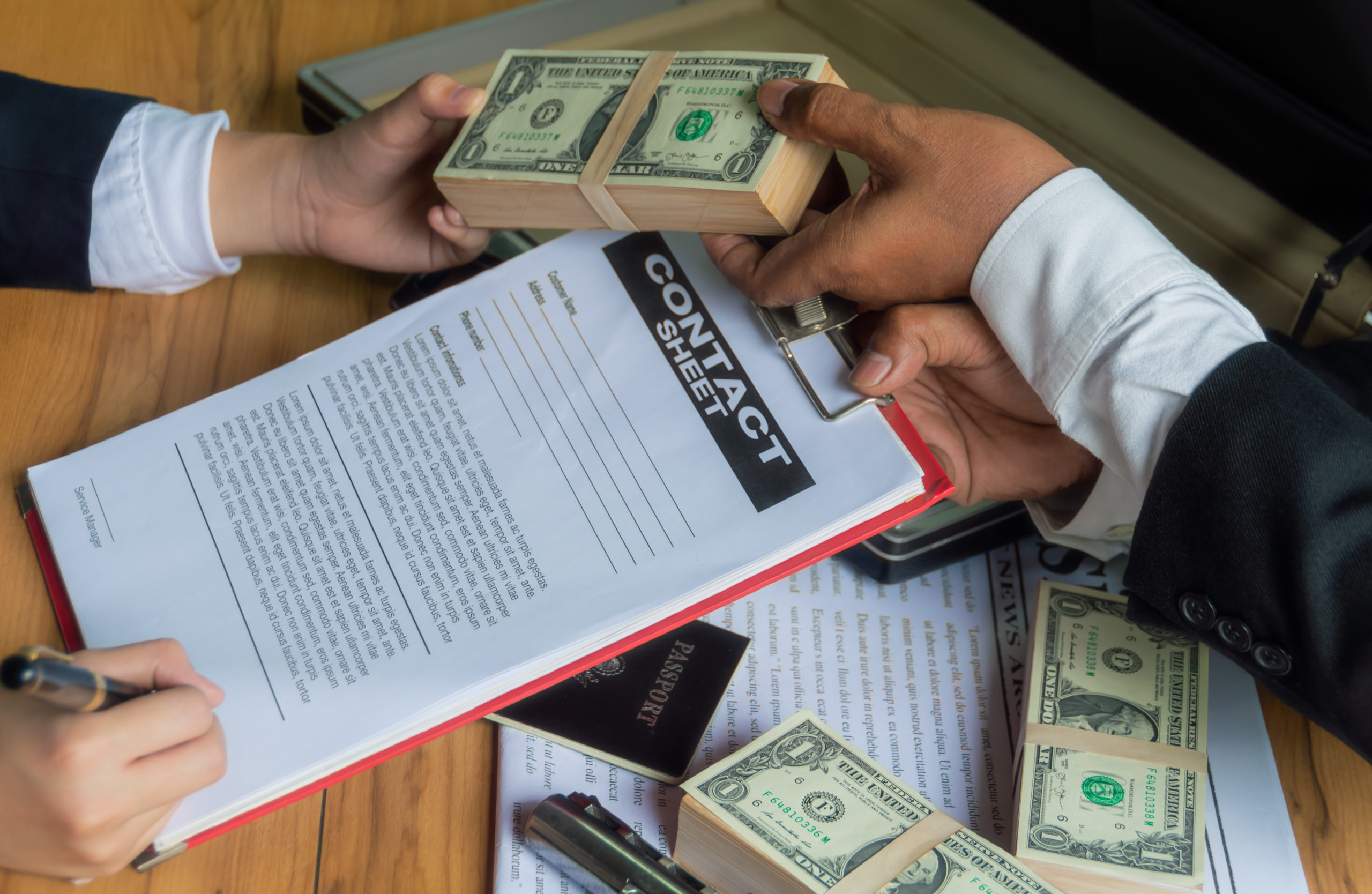 businessmen-use-money-bribe-other-people-exchange-signing-contracts