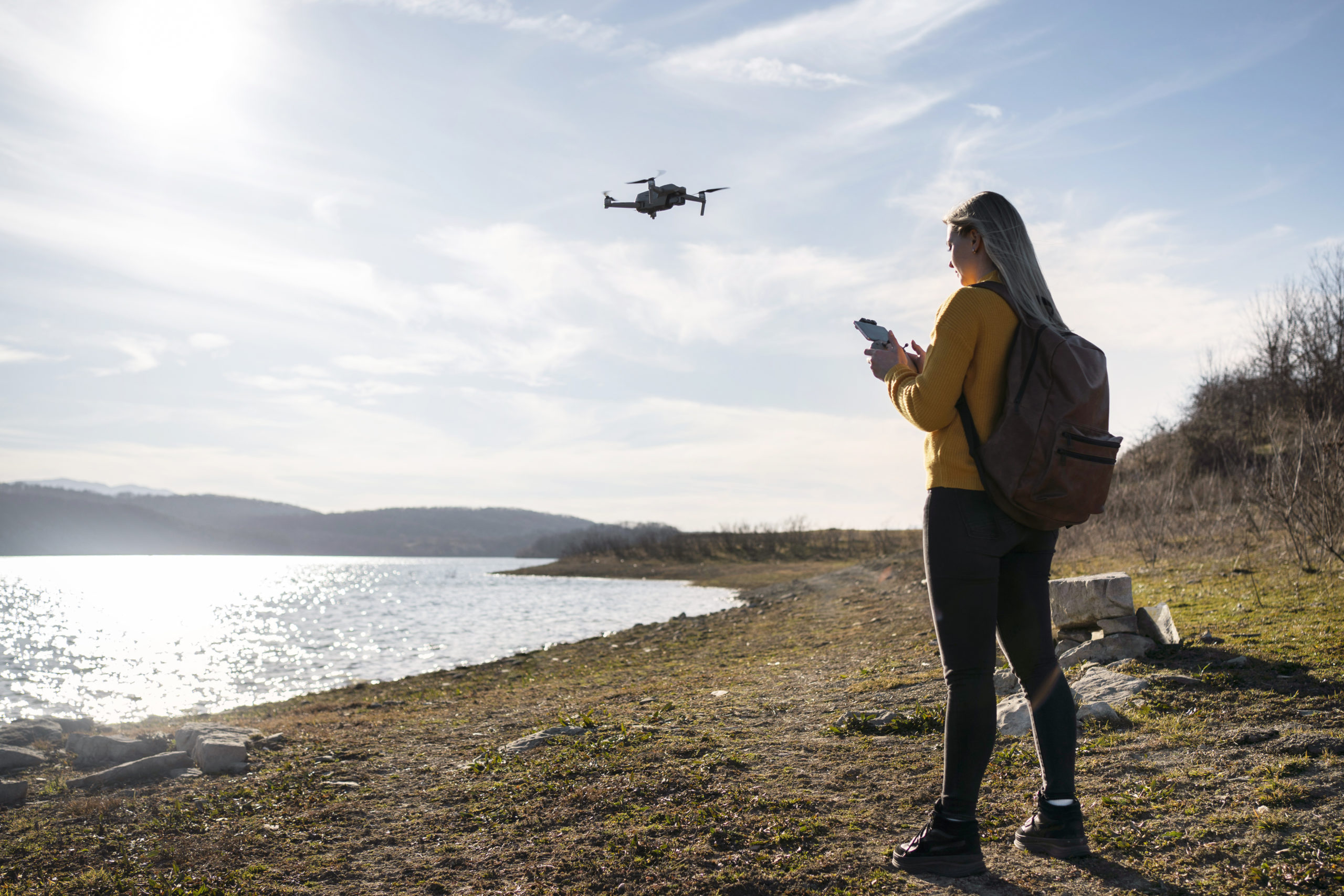 full-shot-woman-with-drone-outdoors